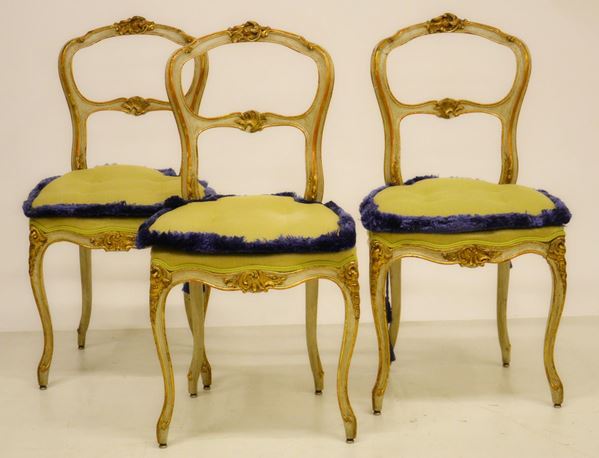 Tre sedie, inizi sec. XX, in legno laccato ed