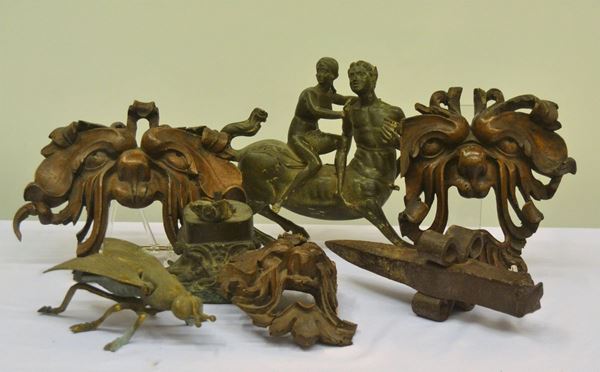 Tre mascheroni, due sculture, un'incudine