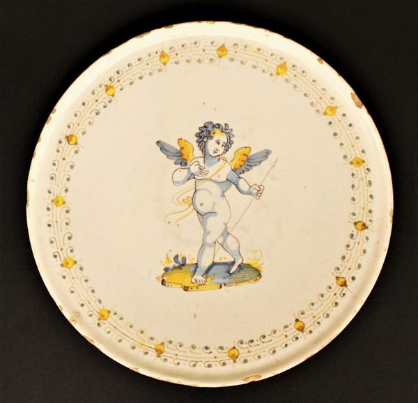 Alzata, Faenza, sec. XVII, in ceramica dipinta decorata al centro putto alato diam. cm 25,5&nbsp;&nbsp;&nbsp;
