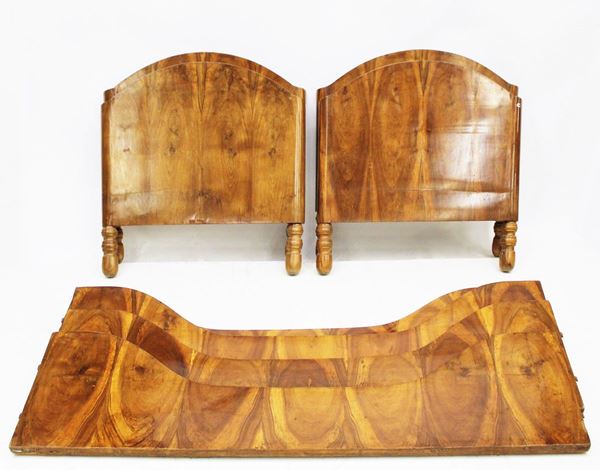 Coppia di letti singoli, sec. XIX, lastronati in piuma di noce, testiere e pediere sagomate, cm 90x200x83 (2)