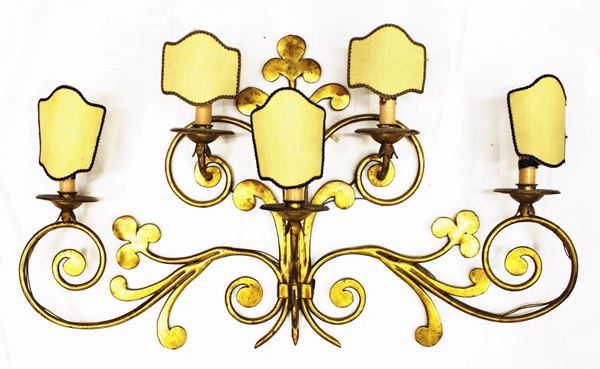 Applique, sec. XX, in ferro, battuto dorato, forgiato ad ampie volute contrapposte, cm 90x53