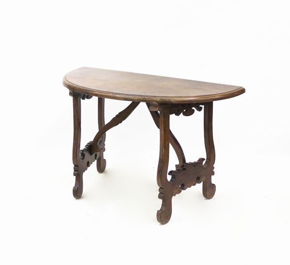 Consolle demilune, sec. XVII, in noce, piano semicircolare, sostegni a lira, traverse lignee modanate, cm 130x63x79,5