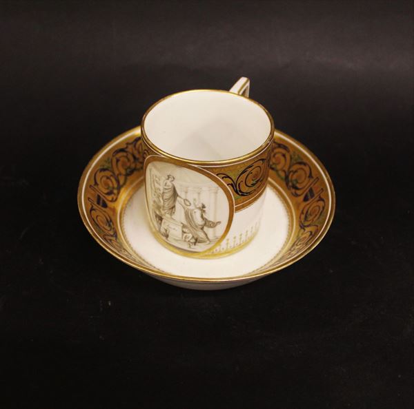 Tazza e piattino, Vienna, 1788,&nbsp; in porcellana bianca, dorata e decorata en grisaille a personaggi classici e cippo iscritto L' amiti&egrave;, volute vegetali in blu e verde su banda dorata, piattino monogrammato, marca scudo blu numerale 88 per l'anno&nbsp;&nbsp;&nbsp;&nbsp;&nbsp;&nbsp;&nbsp;&nbsp;&nbsp;&nbsp;&nbsp;&nbsp;&nbsp;&nbsp;&nbsp;&nbsp;&nbsp;&nbsp;&nbsp;&nbsp;&nbsp;&nbsp;&nbsp;&nbsp;&nbsp;&nbsp;&nbsp;&nbsp;&nbsp;&nbsp;&nbsp;&nbsp;&nbsp;&nbsp;&nbsp;&nbsp;&nbsp;&nbsp;&nbsp;&nbsp;&nbsp;&nbsp;&nbsp;&nbsp;&nbsp;&nbsp;&nbsp;&nbsp;&nbsp;&nbsp;&nbsp;&nbsp;&nbsp;&nbsp;&nbsp;&nbsp;&nbsp;&nbsp;&nbsp;&nbsp;&nbsp;&nbsp;&nbsp;&nbsp;&nbsp;
