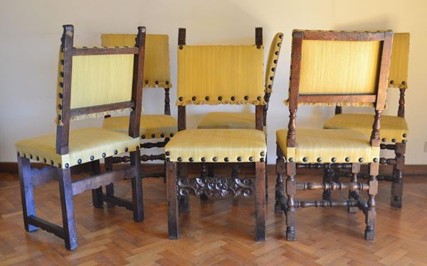 Quattro sedie, sec. XVII, in noce, spalliere e sedute rivestite in stoffa gialla, sostegni torniti e raccordati da traverse