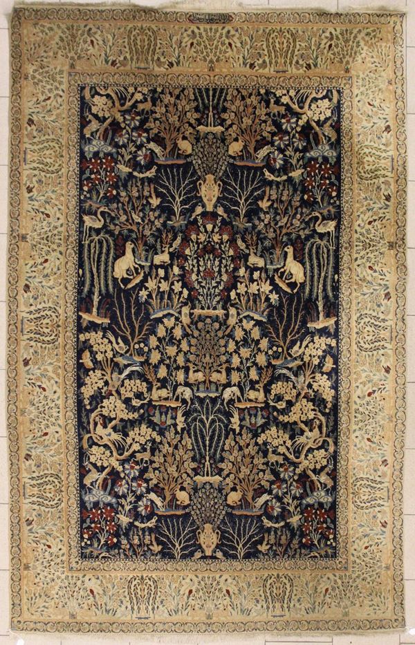 Tappeto, Persia, sec. XX, impianto a motivi fitozoomorfi nei toni su campo blu, fascia di bordura nei toni dell'avana, cm 280x174