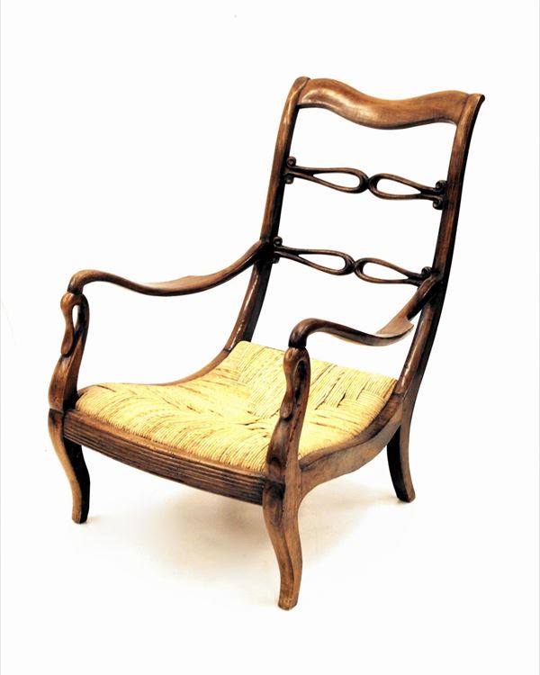 Poltrona, Carlo X, in noce, schienale a giorno sagomato, seduta impagliata, gambe mosse, alt. cm 90