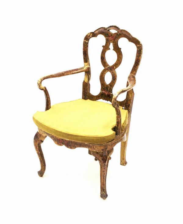 Poltrona, Veneto, secolo XVIII, in legno laccato a fondo giallo e dipinta in policromia con fiori, schienale con cartella verticale traforata, sedile cann&egrave;, gambe frontali mosse, restauri e ampi danni, completa di cuscino in velluto giallo