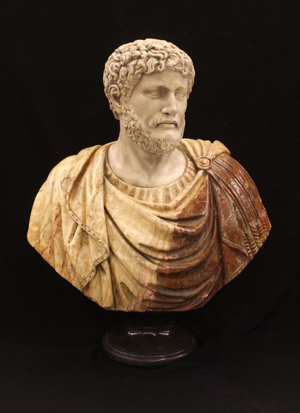 Busto, sec. XX, in marmi policromi su base in marmo nero tornita, alt. cm 82