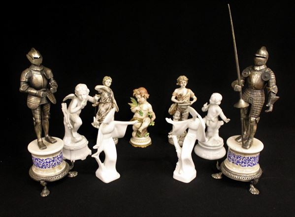 Nove piccole statue, sec. XX, in porcellana e metallo, alt. massima cm 37&nbsp;