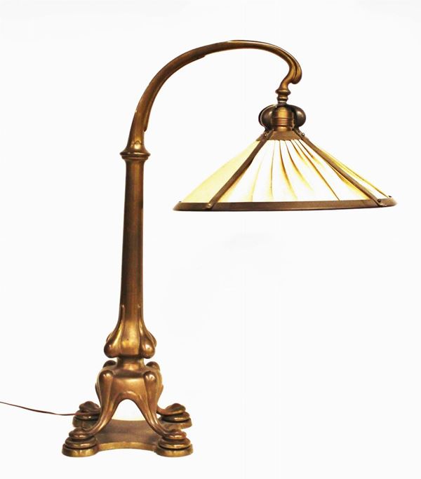 Lampada da tavolo, sec. XX, in ottone fusto modellato a motivi curvilinei,