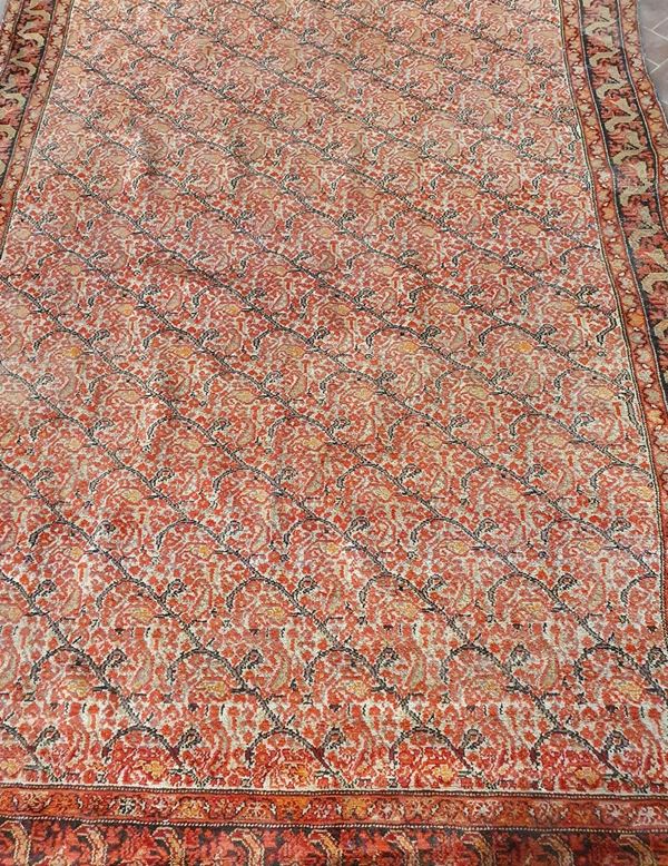 Tappeto persiano, inizi sec. XX, fondo rosso a motivi floreali, cm 190x135,