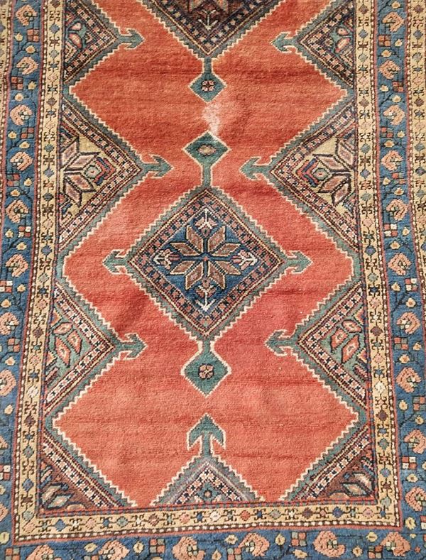 Tappeto Kazak, sec. XX, fondo nei toni del rosso e dell'azzurro, a motivi&nbsp;