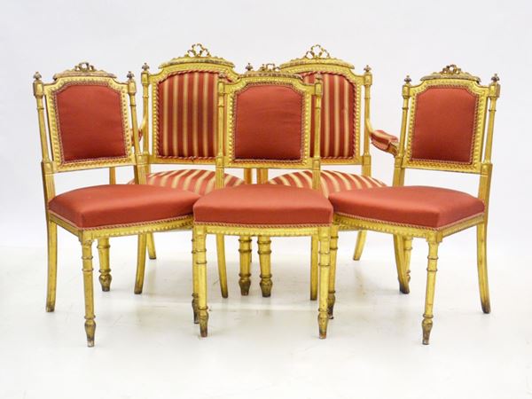 Due poltroncine e tre sedie, sec. XX, in legno dorato, sedute e schienali&nbsp;