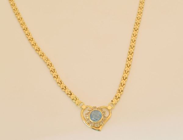 



COLLANA GIROCOLLO IN ORO 18KT CON PENDENTE A CUORE E PIETRA AZZURRA