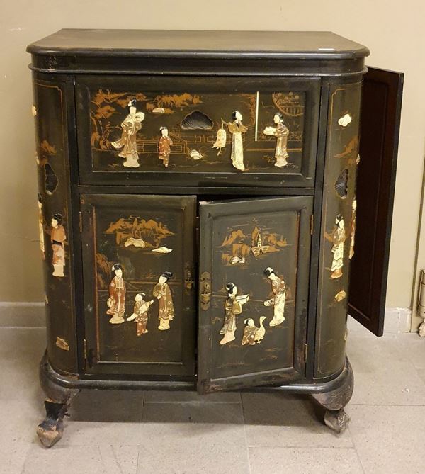 Mobile bar, sec. XX in legno di canfora con decori orientali a rilievo quattro sportelli e piano apribile, cm.92x45x107, difetti