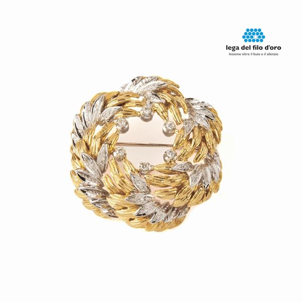 



SPILLA IN ORO GIALLO, ORO BIANCO 18 KT E DIAMANTI